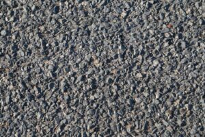 Close-up of freshly laid asphalt with visible stone texture